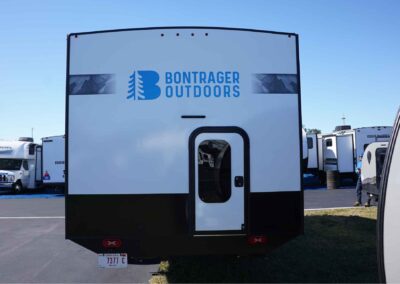 Rear side of the 21' comfort camper, with a small door leading to storage.