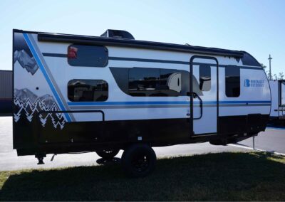 full view of the entrance side of the 21' camper, with the comfort line graphics on the side